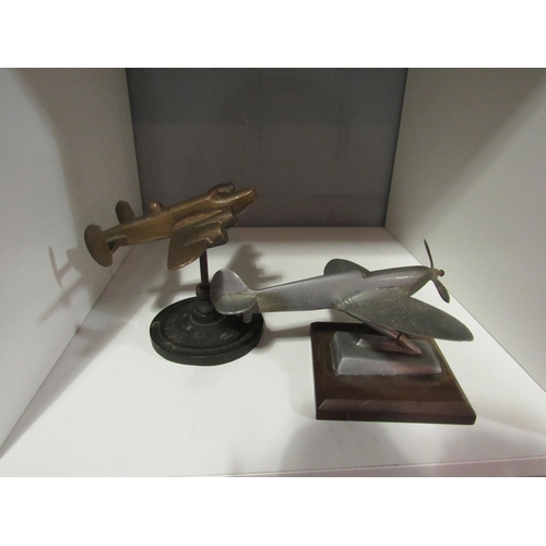 1253 - A 1950's aluminium Spitfire desk ornament (16cmW x 9cmH) and a bronze Lancaster bomber desk ornament... 