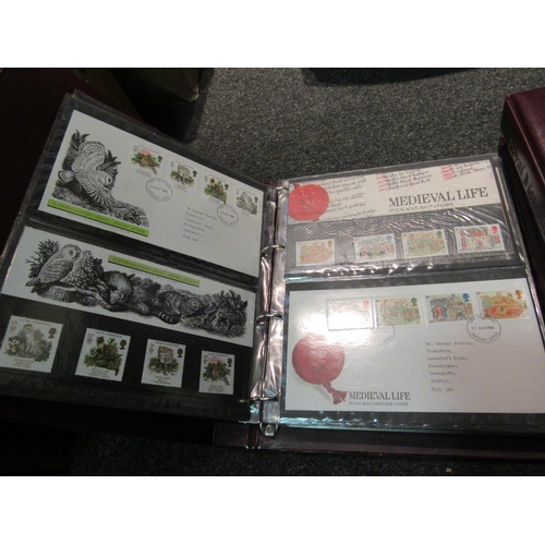 1402 - A box containing three albums of Royal Mail First Day covers and a quantity of stamps