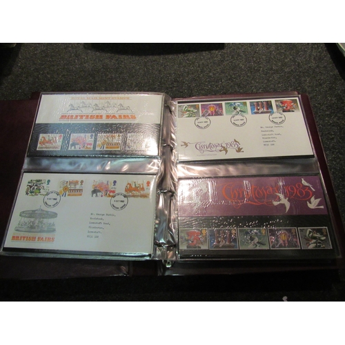 1402 - A box containing three albums of Royal Mail First Day covers and a quantity of stamps