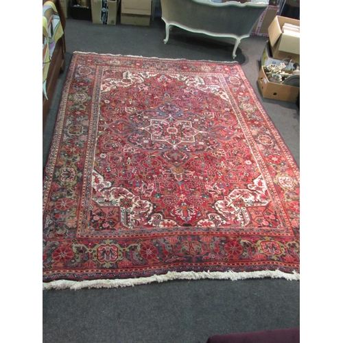 1480 - A red and blue ground wool rug with geometric design, multiple borders and tasselled ends, 290cm x 2... 