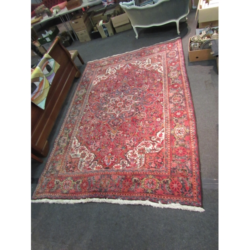 1480 - A red and blue ground wool rug with geometric design, multiple borders and tasselled ends, 290cm x 2... 