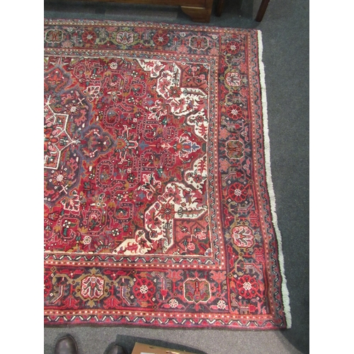 1480 - A red and blue ground wool rug with geometric design, multiple borders and tasselled ends, 290cm x 2... 