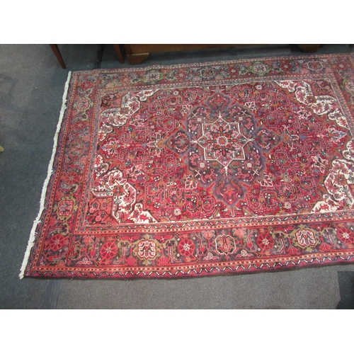 1480 - A red and blue ground wool rug with geometric design, multiple borders and tasselled ends, 290cm x 2... 