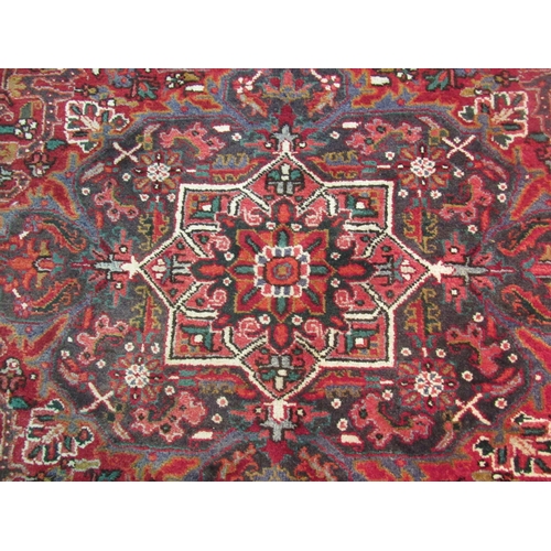 1480 - A red and blue ground wool rug with geometric design, multiple borders and tasselled ends, 290cm x 2... 