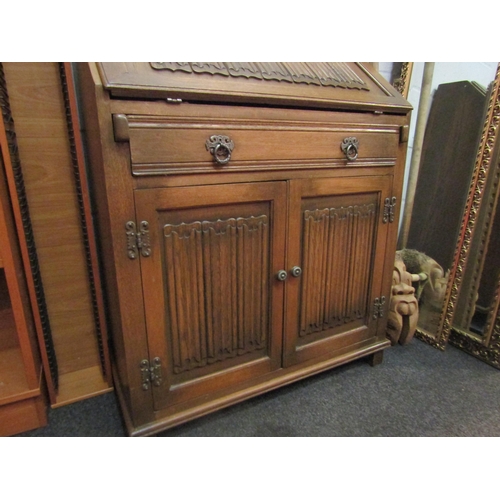 1022 - An Old Charm oak bureau with linenfold design, single drawer and twin door cupboard