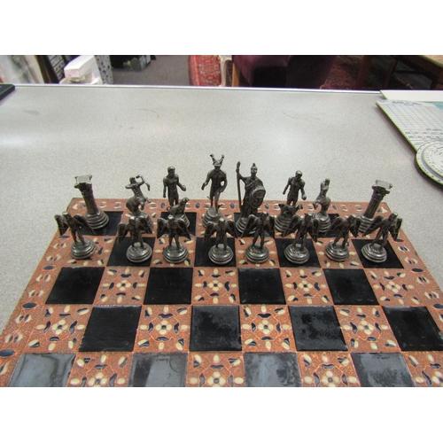 1179 - A copper inlaid chess board on feet complete with 32 fantasy pieces