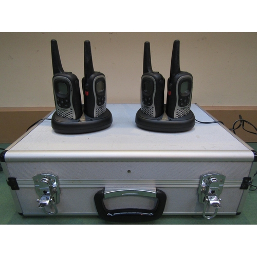 8233 - A set of four Uniden walkie talkies and chargers in associated metal carry case