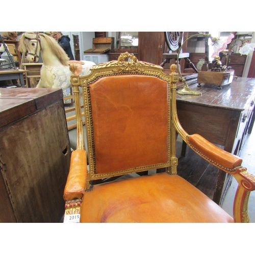 2015 - A carved gilt wood thorne chair with brown leather seat and back