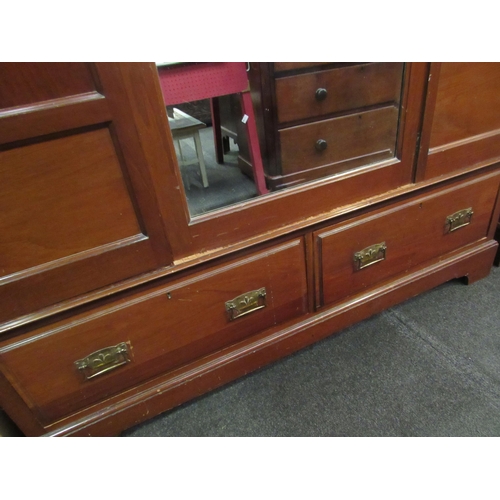 1022 - An Edwardian mahogany wardrobe with central mirrored single door over two base drawers (with key) 20... 