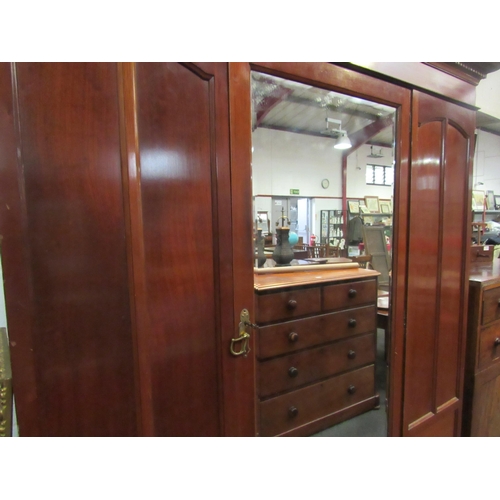 1022 - An Edwardian mahogany wardrobe with central mirrored single door over two base drawers (with key) 20... 