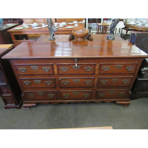 1129 - A 19th Century mahogany false front chest of three lower drawers with lift-up top and on bracket fee... 