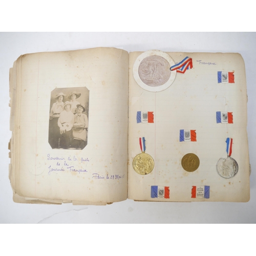 9105 - A World War 1 souvenir album containing photographs, postcards, manuscript pen & ink sketches and en... 