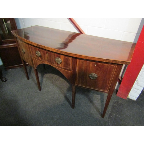 1004 - A Georgian style bow-fronted mahogany sideboard with central drawer flanked by two side drawers.  Va... 