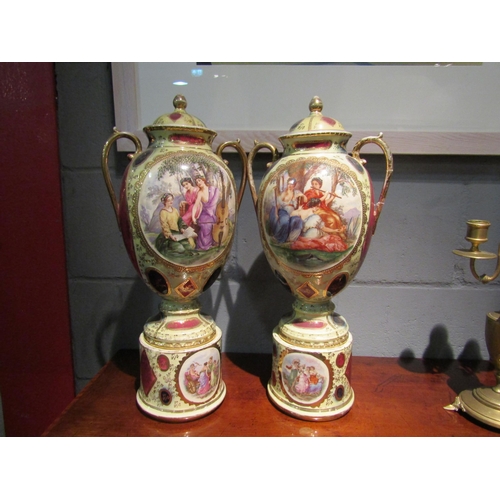 1070 - A pair of early 20th Century lidded urns on plinths with classical cartouches, approximately 48cm hi... 