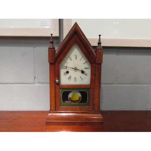 1071 - An American mantel clock with painted glass panel depicting a beehive, arch top, 44.5cm high