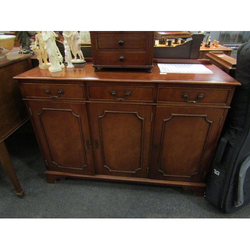 1123 - A reproduction Regency mahogany sideboard, the three drawers over three cupboard doors, bracket feet... 