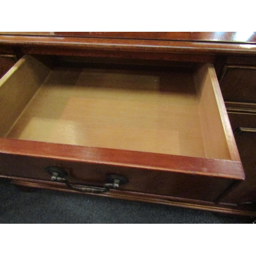 1123 - A reproduction Regency mahogany sideboard, the three drawers over three cupboard doors, bracket feet... 