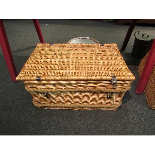 1135 - A large wicker hamper basket with rope handles, 66cm long