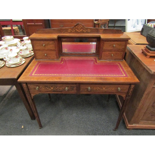 1147 - An Edwardian walnut lady’s writing desk, foliate marquetry, mirrored gallery back over tooled red le... 