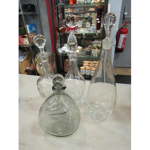 1464 - Four decanters including crystal and smoked glass, 38cm talles, 24cm smallest   (E)  £10-15