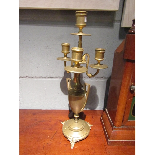 1071A - A pair of brass candelabra in the neo-classical style   (E) £20-30