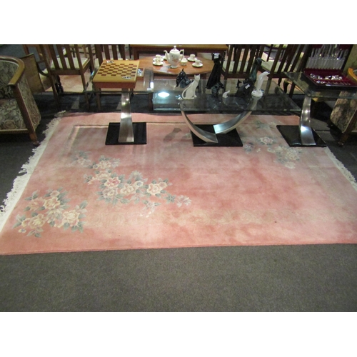 1473 - A modern Chinese pink ground floral decorated rug, 276cm x 183cm