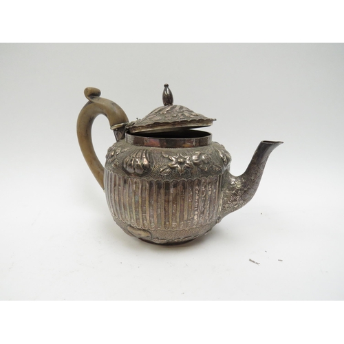 5003 - A Victorian silver teapot, floral relief, marks indistinct, fluted body, 428g