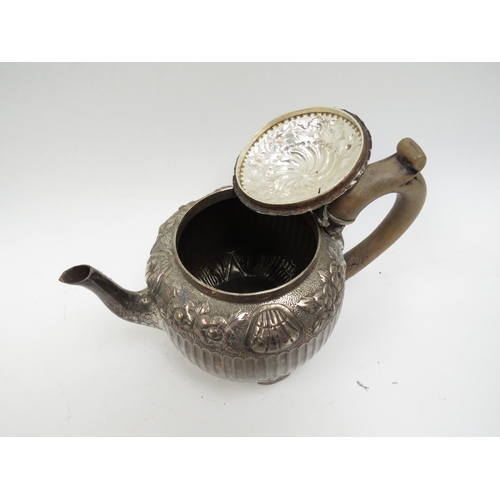 5003 - A Victorian silver teapot, floral relief, marks indistinct, fluted body, 428g