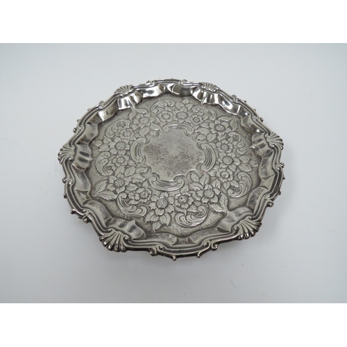 5011 - A George II William Peaston silver waiter with repousse floral border, London 1754, 17.5cm diameter,... 