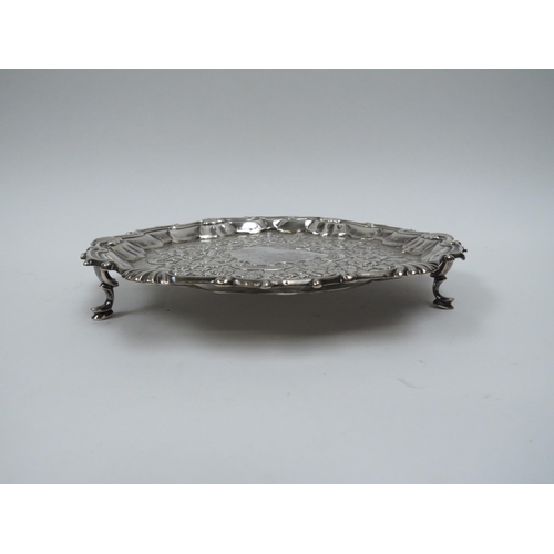 5011 - A George II William Peaston silver waiter with repousse floral border, London 1754, 17.5cm diameter,... 