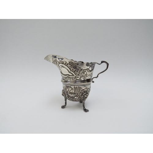 5016 - A T. Hill silver repoussé milk jug on three legs, decorated with ducks, fox, swan and dolphin, Birmi... 