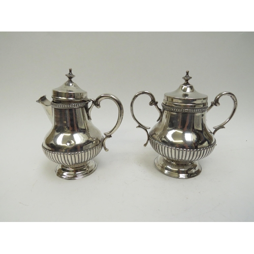 5041 - A Portuguese silver lidded coffee canister and pot with melon fluted detail, 16cm tall, 593g, missha... 