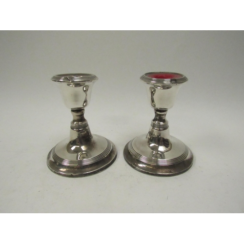 5063 - A pair of William Aitken silver candlesticks with reeded band detail, Birmingham 1919, weighted base... 