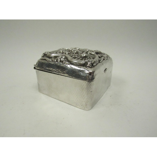 5072 - A Chinese export silver lidded box with high relief decoration of Dragon chasing flaming pearl, char... 