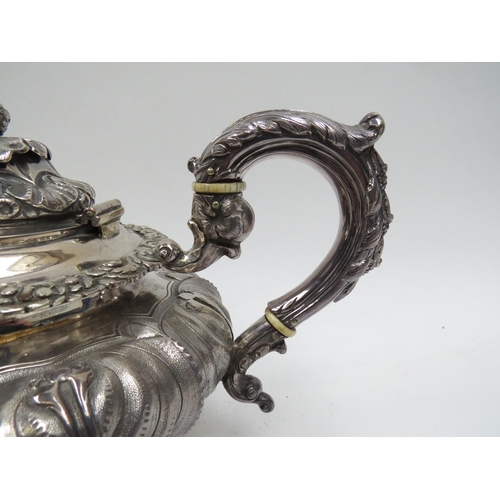 5098 - A Smith & Gamble silver teapot, all over foliate relief, Dublin 1832, inscribed cartouches, ivory in... 