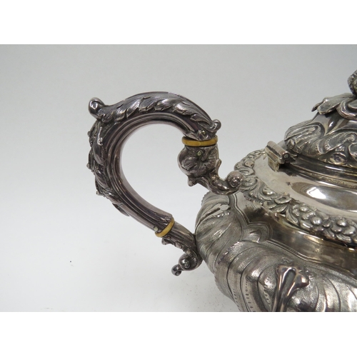 5098 - A Smith & Gamble silver teapot, all over foliate relief, Dublin 1832, inscribed cartouches, ivory in... 