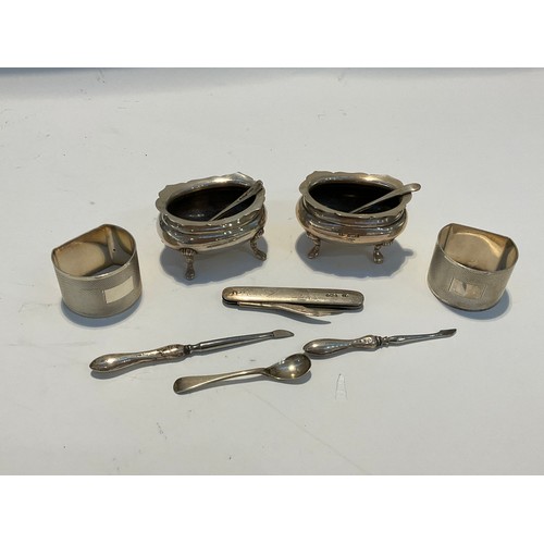 5065 - A quantity of silver items including napkin rings, a pair of table salts and a penknife etc. Napkin ... 