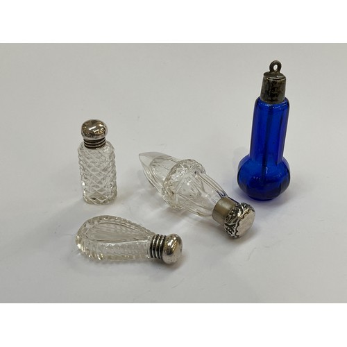 5213 - Three miniature scent bottles with silver lids and clear glass bodies, together with a blue glass sn... 