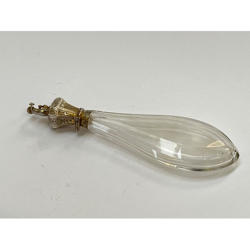 5214 - A continental white metal and cut glass scent bottle of faceted teardrop form, the lid surmounted by... 