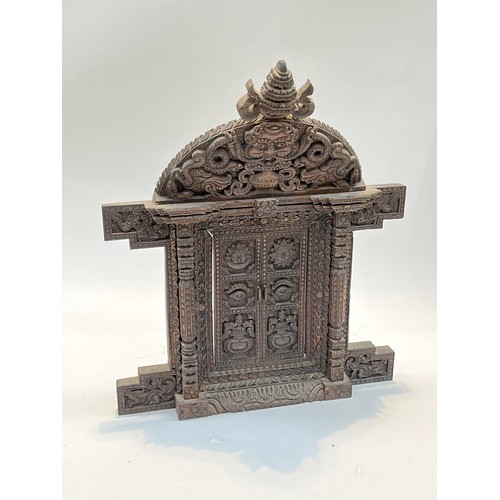 5226 - A carved wood decorative table top doorway from Kathmandu, Nepal, 46cm tall