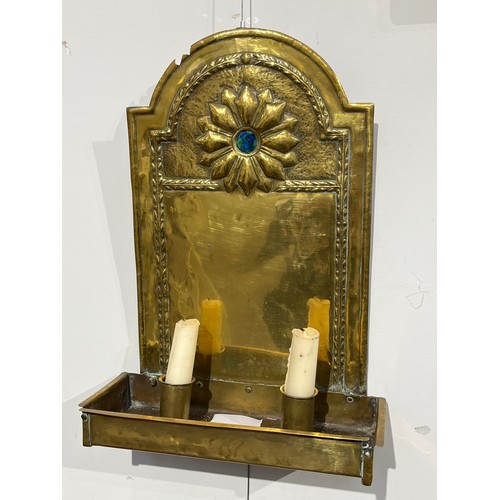 5233 - An Arts and Crafts wall hanging double candle sconce with brass arched back plate with hammered deco... 