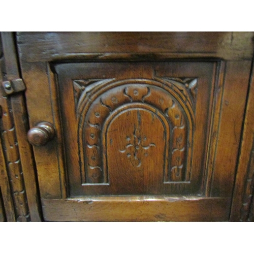 4126 - A Titchmarsh & Goodwin 17th Century revival carved and pegged oak court cupboard, the raised two doo... 