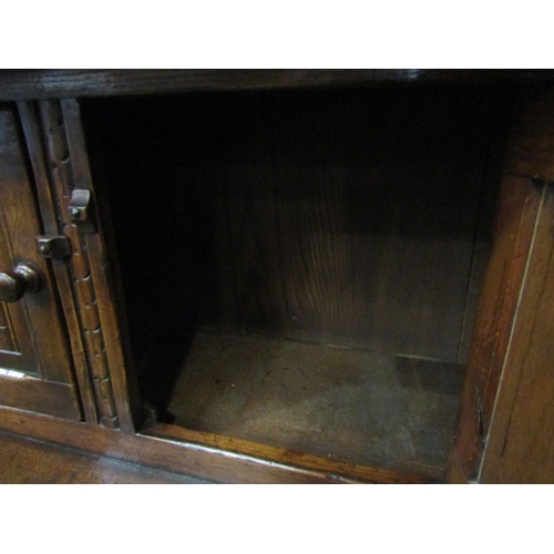 4126 - A Titchmarsh & Goodwin 17th Century revival carved and pegged oak court cupboard, the raised two doo... 