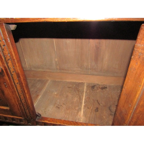 4126 - A Titchmarsh & Goodwin 17th Century revival carved and pegged oak court cupboard, the raised two doo... 