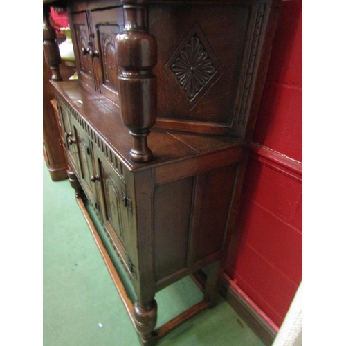 4126 - A Titchmarsh & Goodwin 17th Century revival carved and pegged oak court cupboard, the raised two doo... 