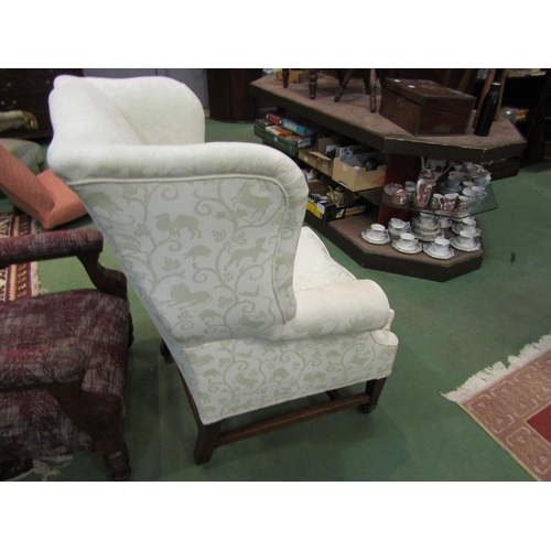 4172 - A George III mahogany wingback fireside armchair with embossed animal upholstery over square taperin... 