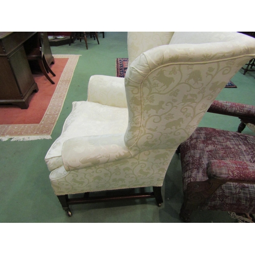 4172 - A George III mahogany wingback fireside armchair with embossed animal upholstery over square taperin... 