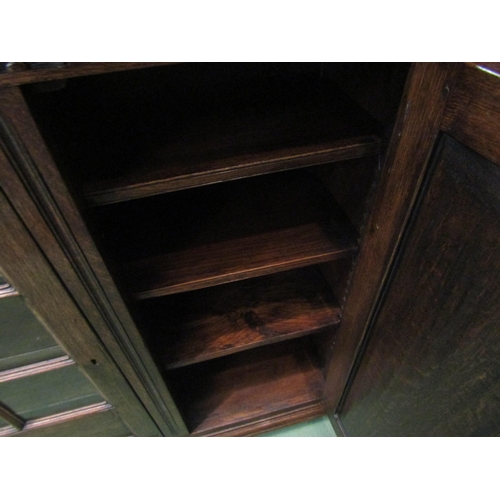 4186 - A Titchmarsh & Goodwin 17th Century revival carved and pegged oak bookcase of three doors (two panel... 