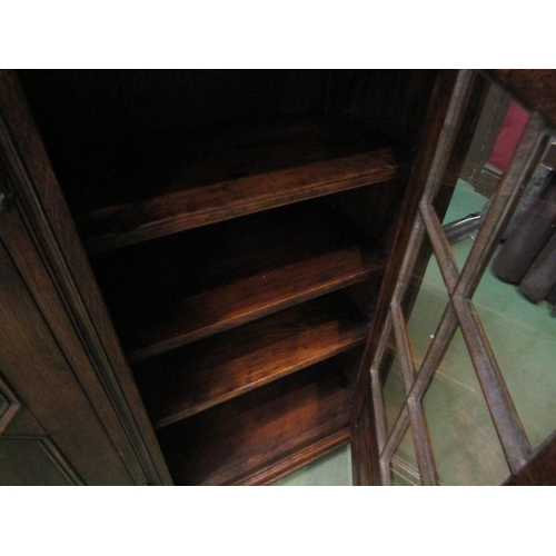 4186 - A Titchmarsh & Goodwin 17th Century revival carved and pegged oak bookcase of three doors (two panel... 