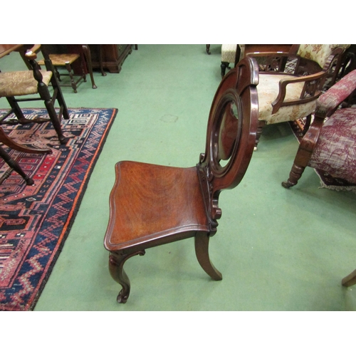 4217 - Circa 1840 a mahogany hall chair, the shield shape back rest over a serpentine front seat on carved ... 